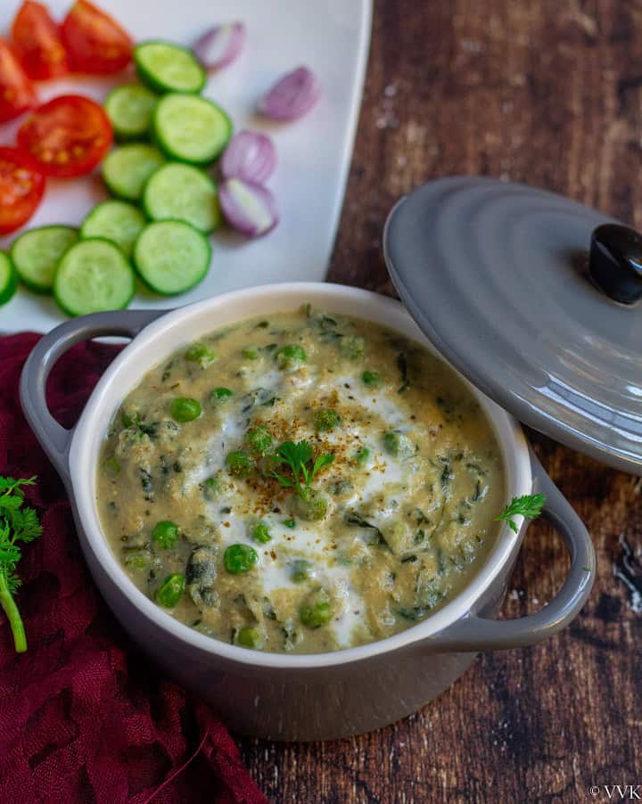 methi matar malai in a small casserole with salad on the side