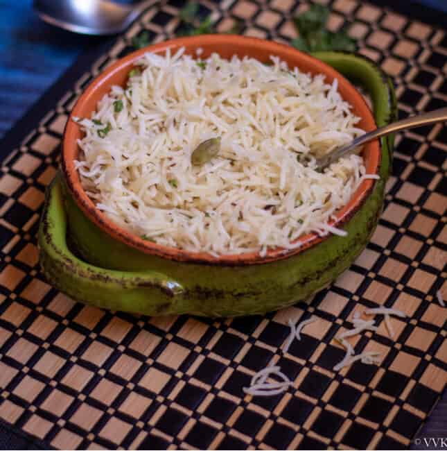 square image of jeera rice made in instant pot served in a terracotta bowl