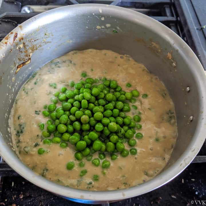 adding peas to the fenugreek curry