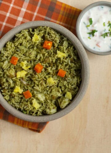 square image of pudina rice served in a ceramic bowl with raita