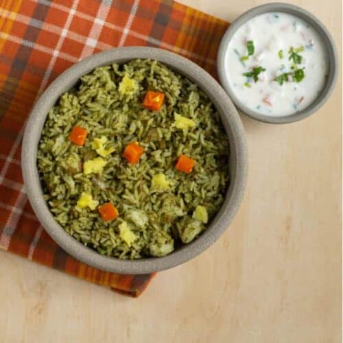 square image of pudina rice served in a ceramic bowl with raita