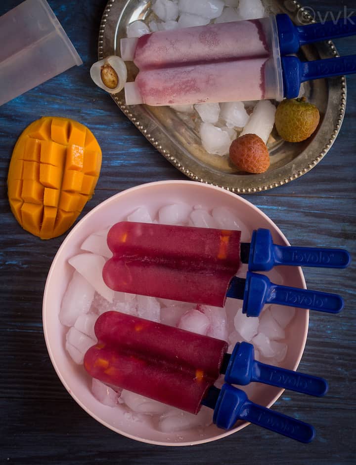 black currant popsicle in a pink bowl with ice cubes