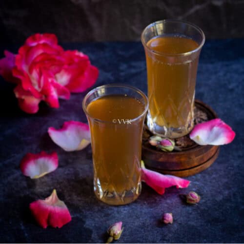 paneer soda served in two glasses with roses on the side