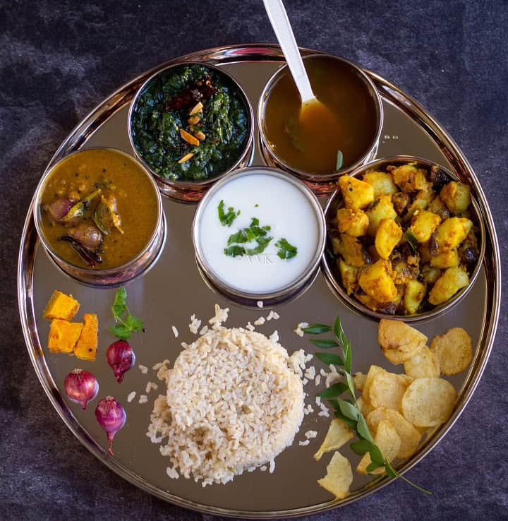 south indian lunch menu with rice, sambar, poriyal, kootu and chips