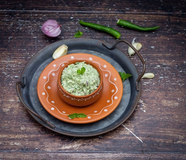 biryani chutney served in terracotta bowl placed on stacked trays