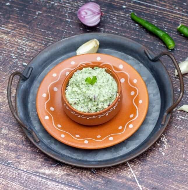 biryani chutney served in terracotta bowl placed on stacked trays