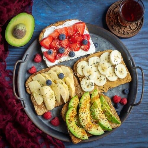 square image of 4 breakfast toast placed on a rustic serveware