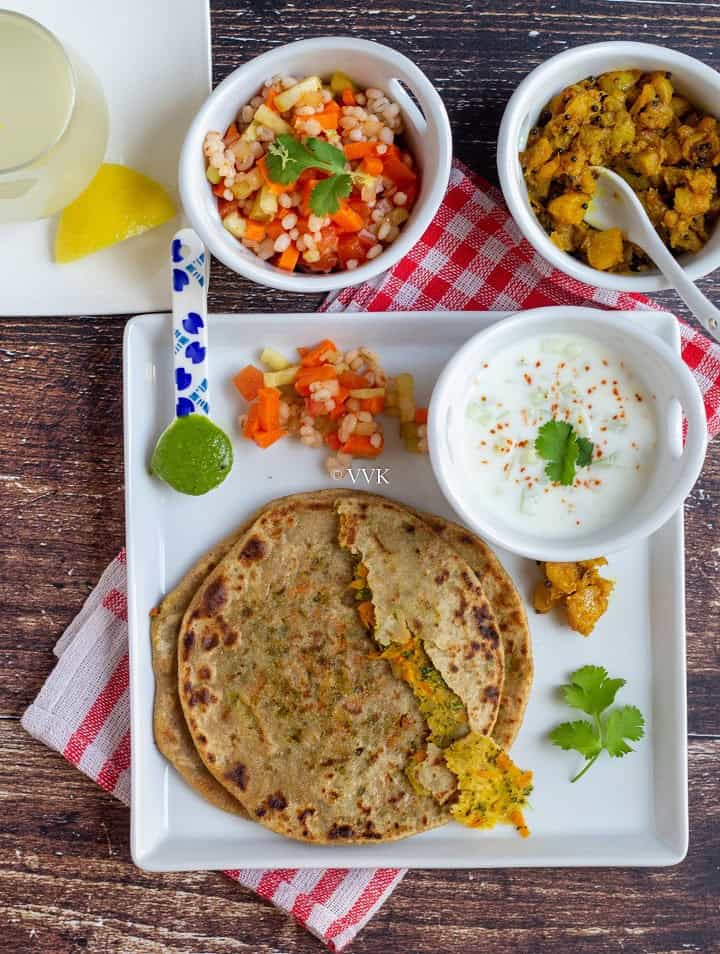 overhead shot of broccoli carrot lunch paratha thali