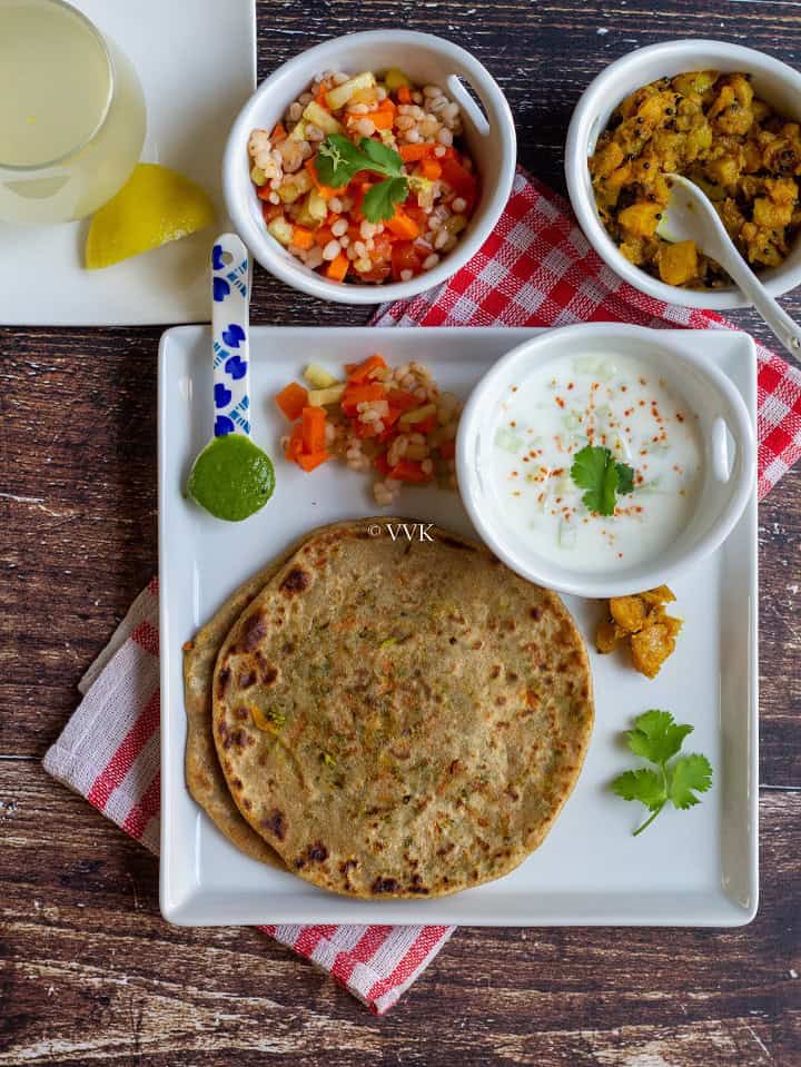 overhead shot of broccoli carrot lunch paratha thali