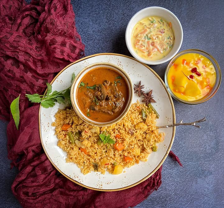 overhead shot of chettinad veg biryani platter