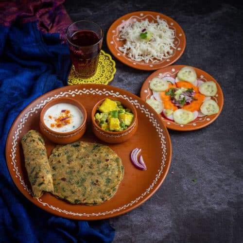 methi paratha thali with paneer and rice and salad
