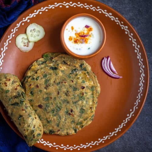 methi paratha in clay plate with raita
