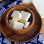 square image of paneer in a wooden bowl