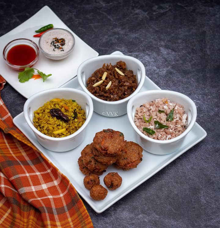 poha platter with two upma, one sweet and appetizer served with chutney and ketchup