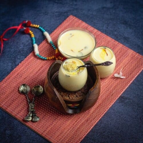 quinoa kheer in a small glass jar placed on a wooden coasters