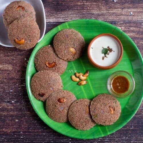 square image of instant ragi rava idli served in green plate with chuntey and podi