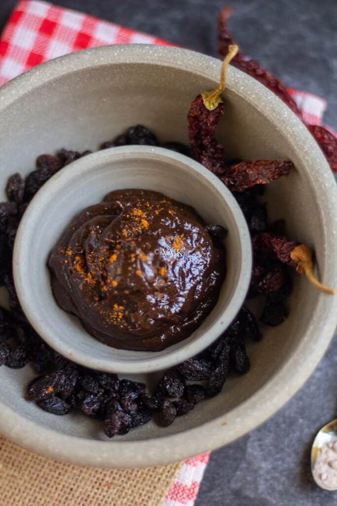 raisin chutney placed on bowl filled with raisins