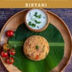 millet biryani served on a wooden plate lined with banana leaf