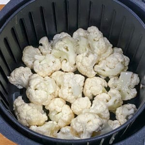 placing the cauliflower in air fryer basket