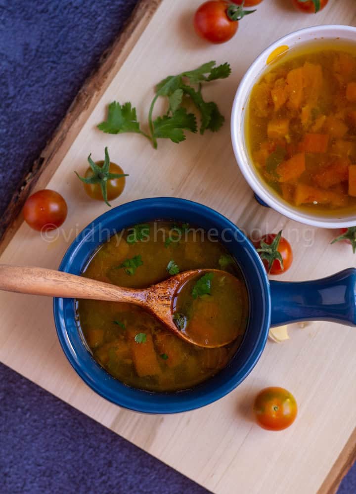 instant pot rasam served in blue ceramic ware