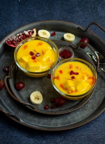 square image of fruit custard served in two bowls placed on rustic tray