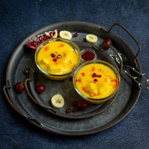 square image of fruit custard served in two bowls placed on rustic tray