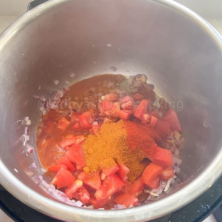 adding tomato paste and spices
