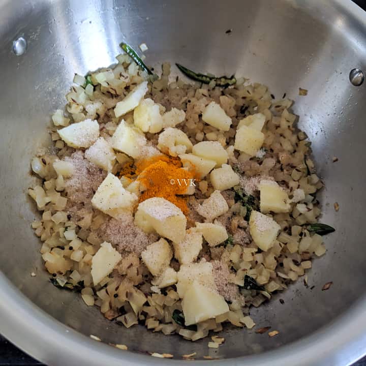 adding potatoes, salt and turmeric