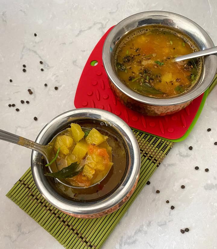 close up shot of pineapple rasam served in two copperserveware