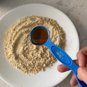 adding honey to millet flour