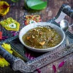 square image of zucchini halwa served on a bowl placed on a silver tray