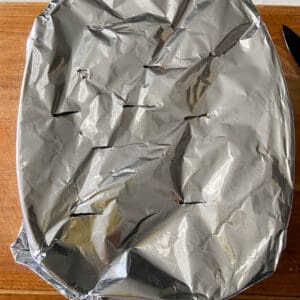 covering the baking dish with aluminum foil