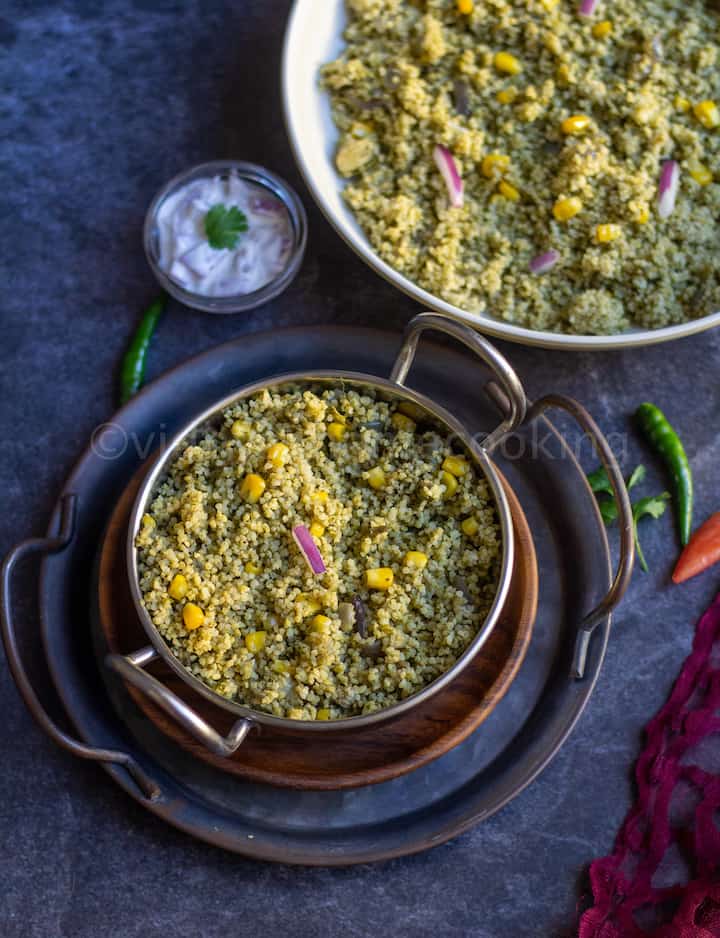instant pot millet palak pulao served in kadai bowl stacked on trays with raita on the side