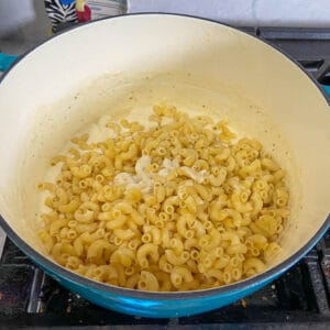 adding pasta and reserved water