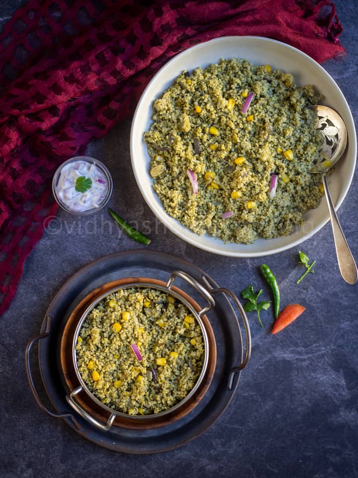 instant pot millet palak pulao served in kadai bowl stacked on trays with raita on the side