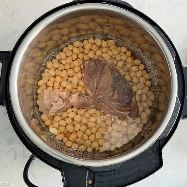 adding the soaked chipeas with potli into the instant pot