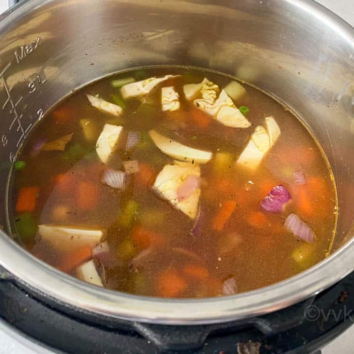 adding the broth and cooking the pasta