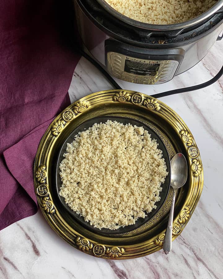 barnyard millet placed in black plate on top of golden plate with instant pot on the top