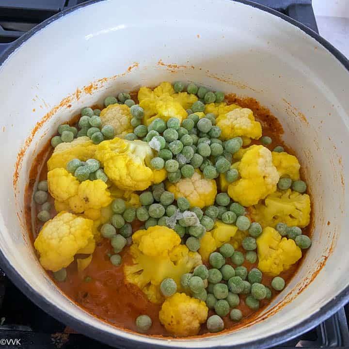 adding the cauliflower and green peas