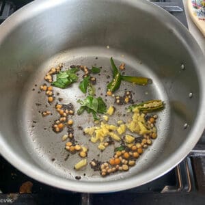 tempering with mustard seeds, urad dal, chana dal and ginger and chilies