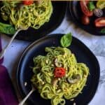 pesto pasta served in black plate with text overlay for pinterest