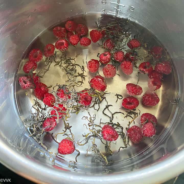 fresh raspberries and green tea with water in the inner pot of the IP