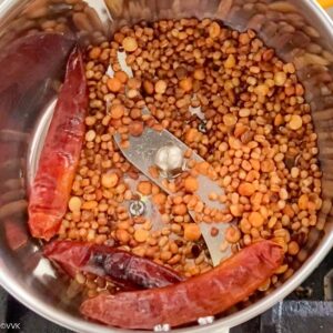 transferring the roasted lentils to a mixer jar