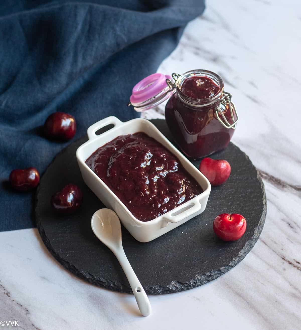 cherry relish in white serveware and in glass jar with cherries on the side