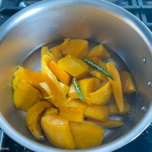 cooking the mangoes with green chili for the curry