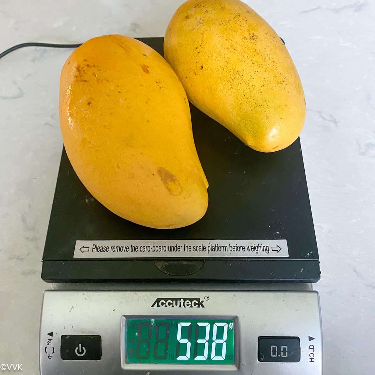 mango placed on a weighing scale