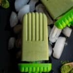 close up shot of matcha popsicle placed on ice cubes on a black slate board