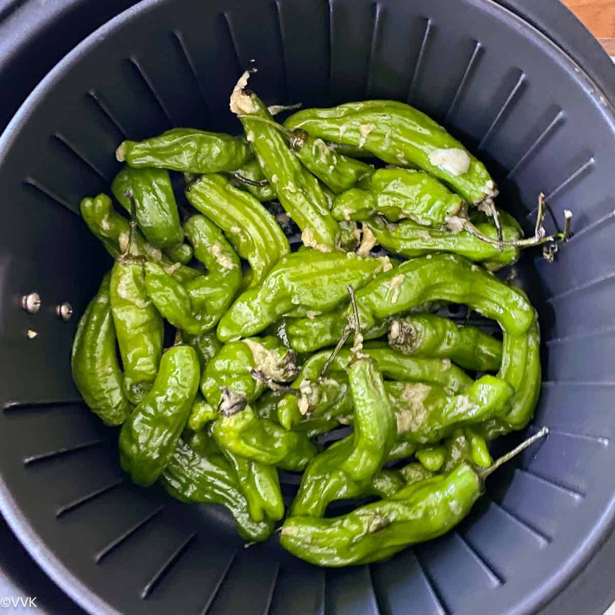 adding the peppers to the air fryer