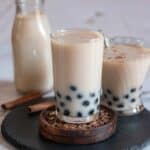 square image of horchata boba served in glass placed on wooden coaster