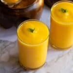 close up shot of tropical mango smoothie served in two glasses